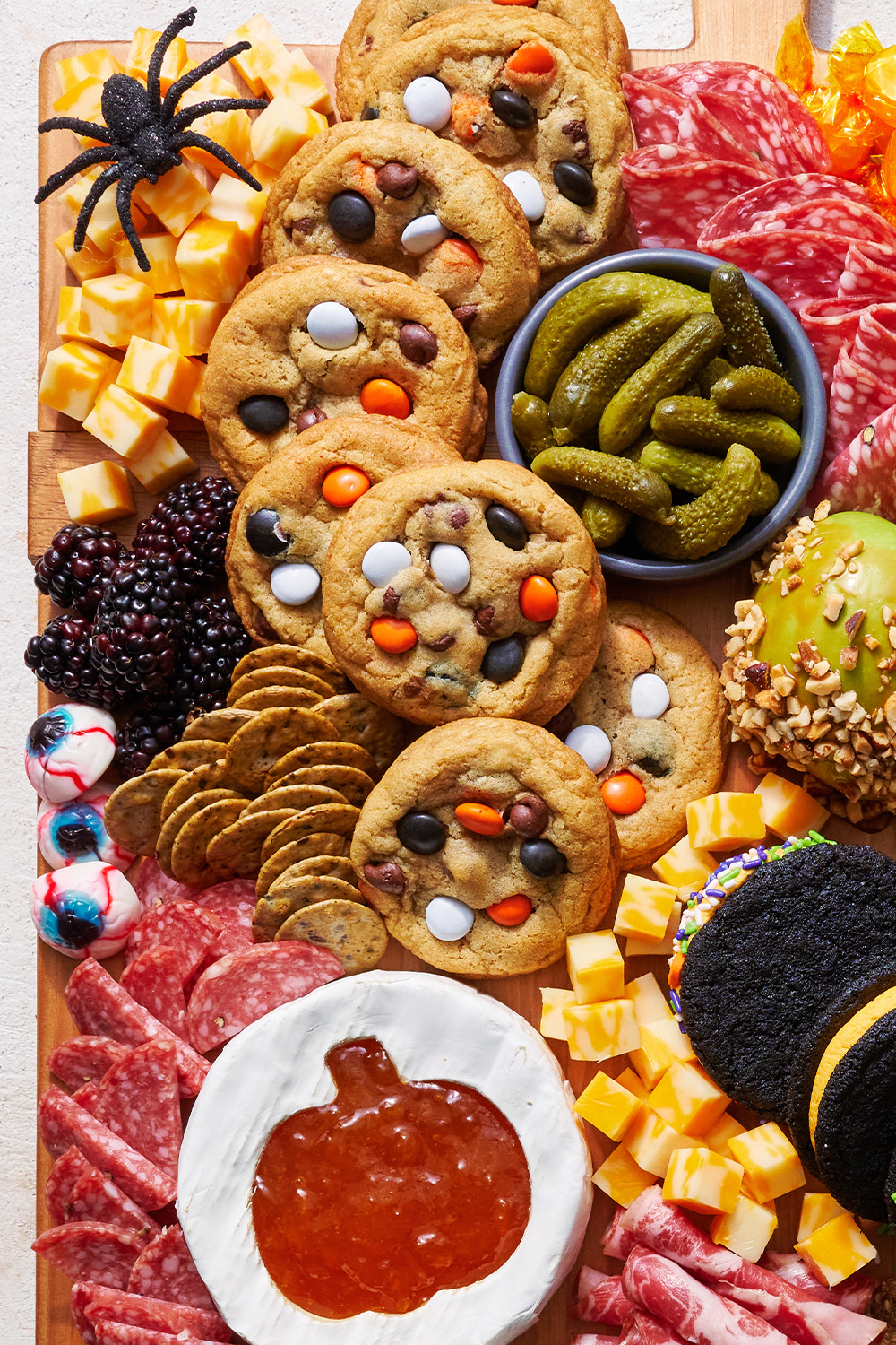closeup of cookies, cheese, candies and pickles on the Halloween Charcuterie Board