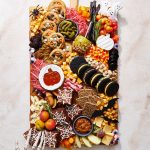 halloween charcuterie board, ready to place on your party table, filled completely with sweet and savory snacks