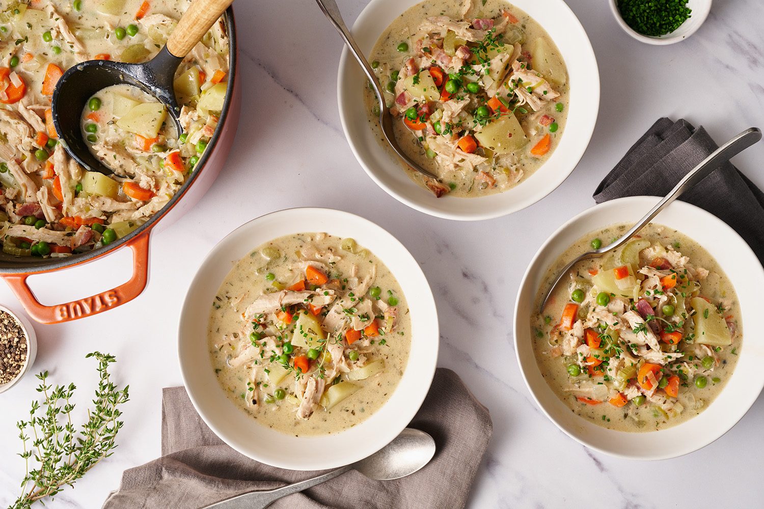 bowls of pot pie soup served in white bowls