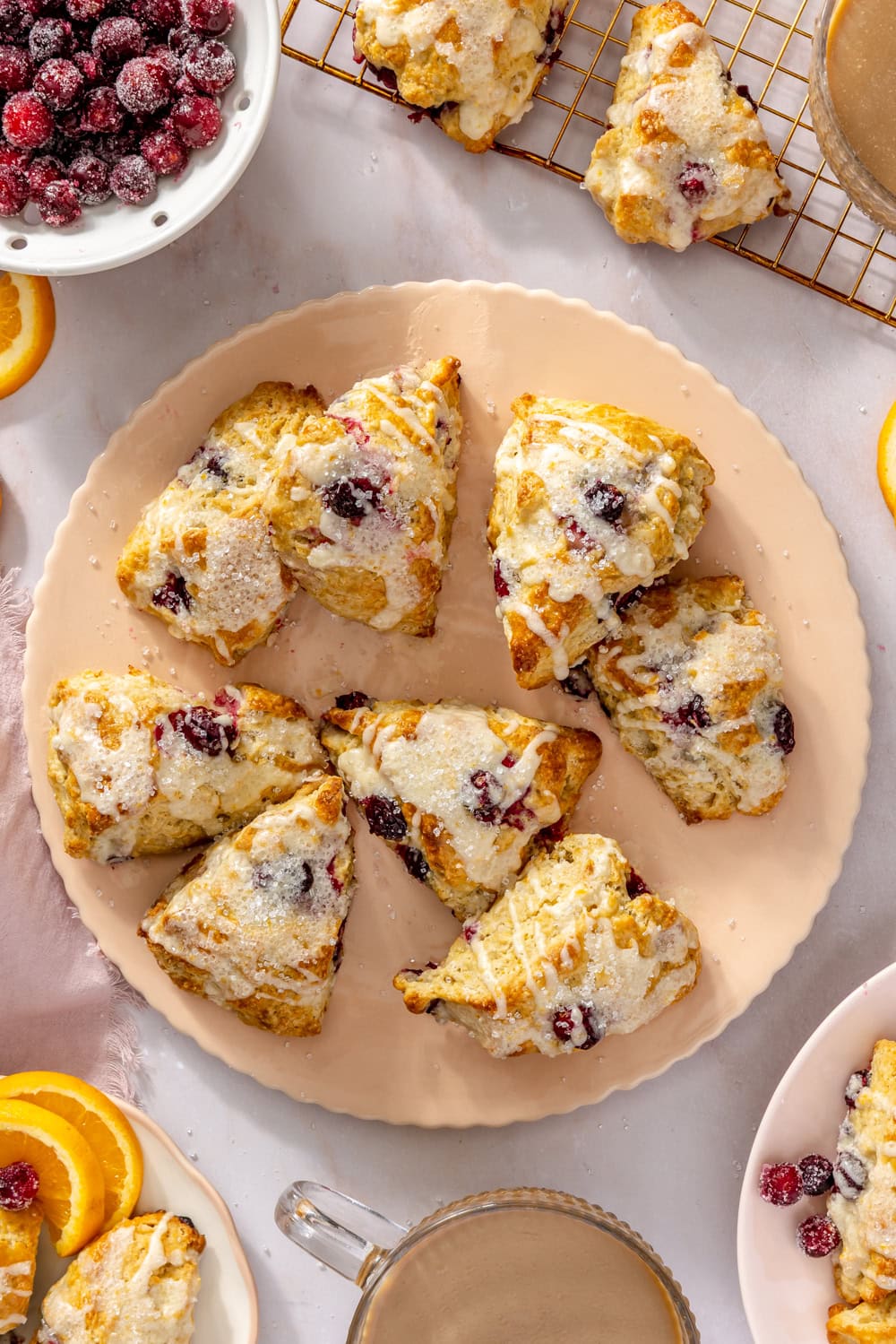 cranberry orange scones on a pale pink decorative plater