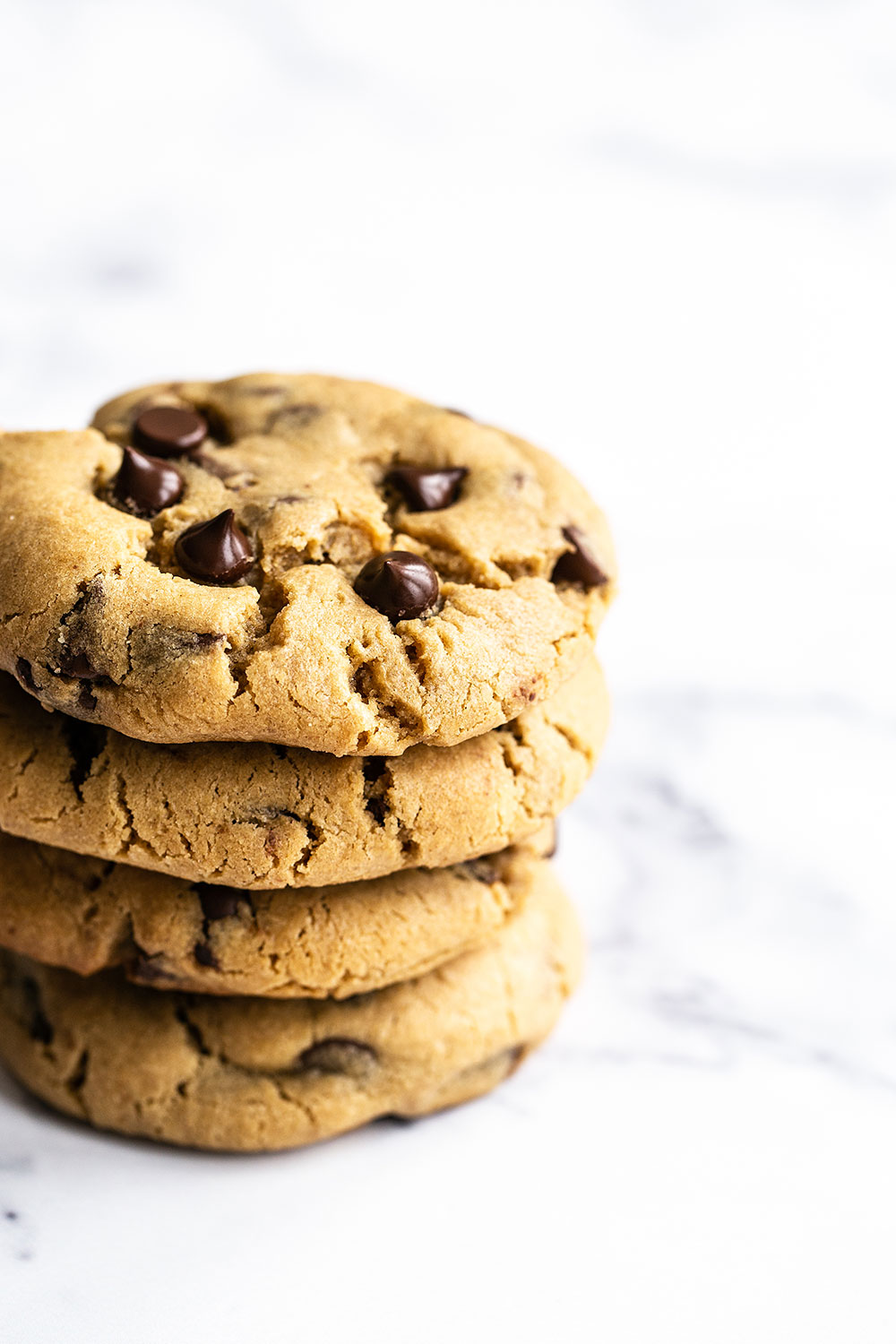 Easy chewy Peanut Butter Chocolate Chip Cookies, stacked several high