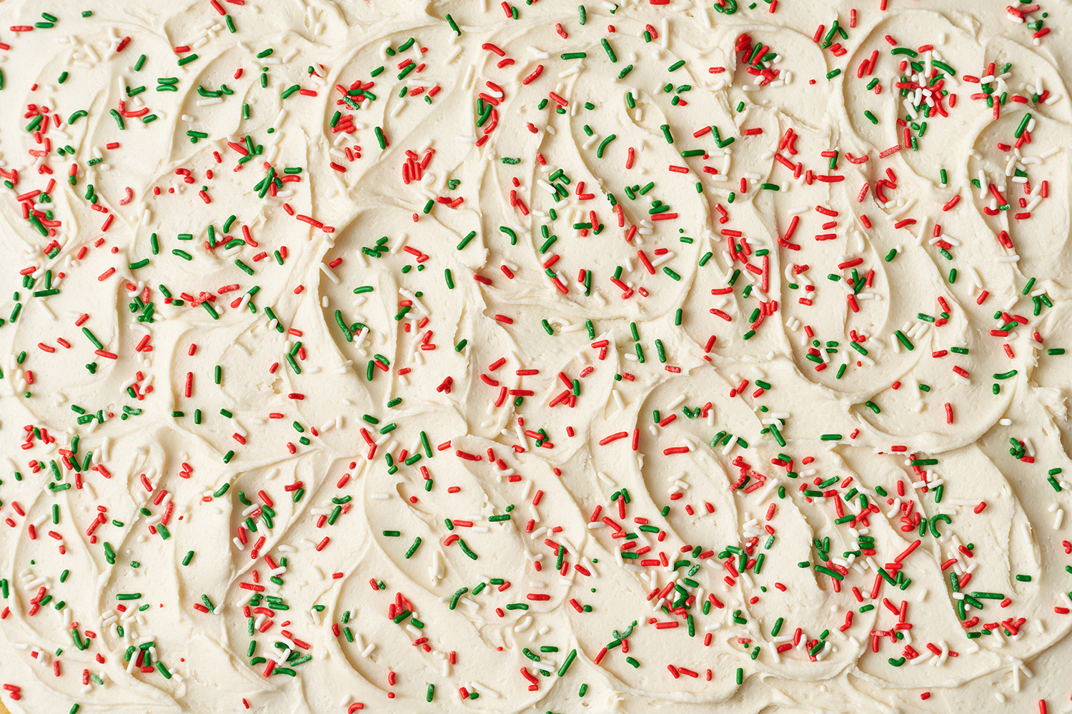 close up of the frosting with holiday jimmies across the top.