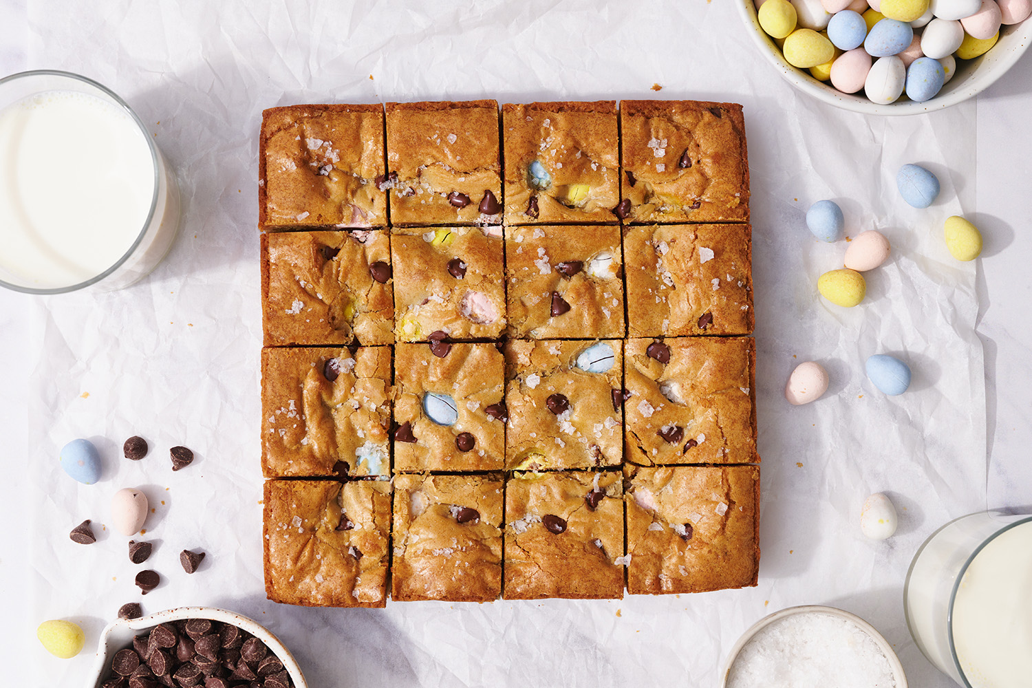 full slab of Easter Blondies surrounded by more chocolate eggs.