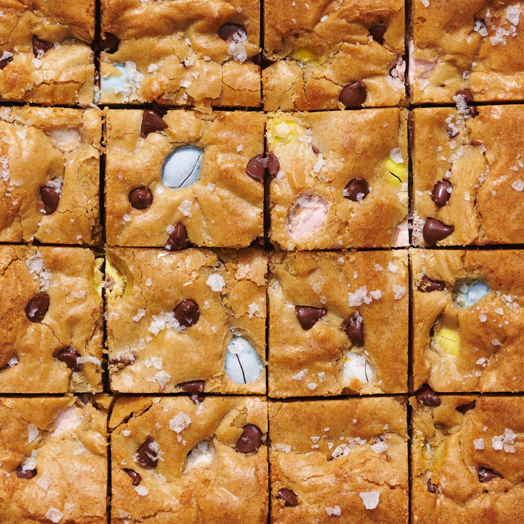 blondies sliced into perfect squares, with lots of pastel mini chocolate eggs visible.
