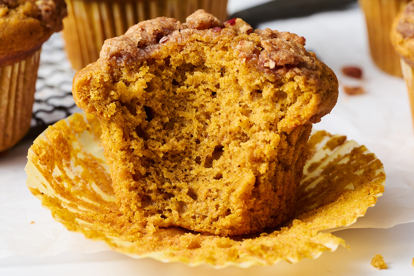 fresh baked pumpkin streusel muffin with a bite taken out
