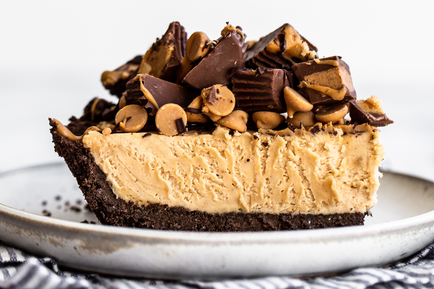 a slice of peanut butter pie on a plate, ready to serve.