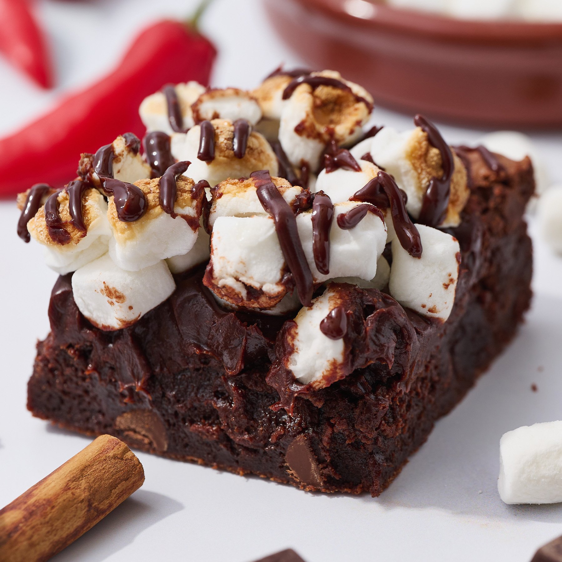 A Mexican hot chocolate brownie topped with marshmallows and chocolate drizzle