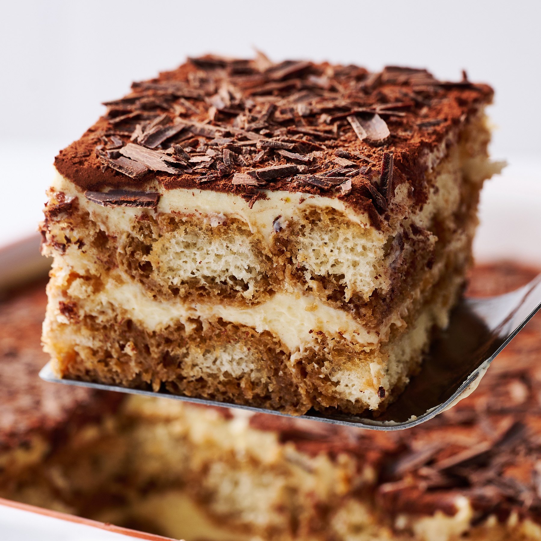 serving of homemade tiramisu being lifted from dish