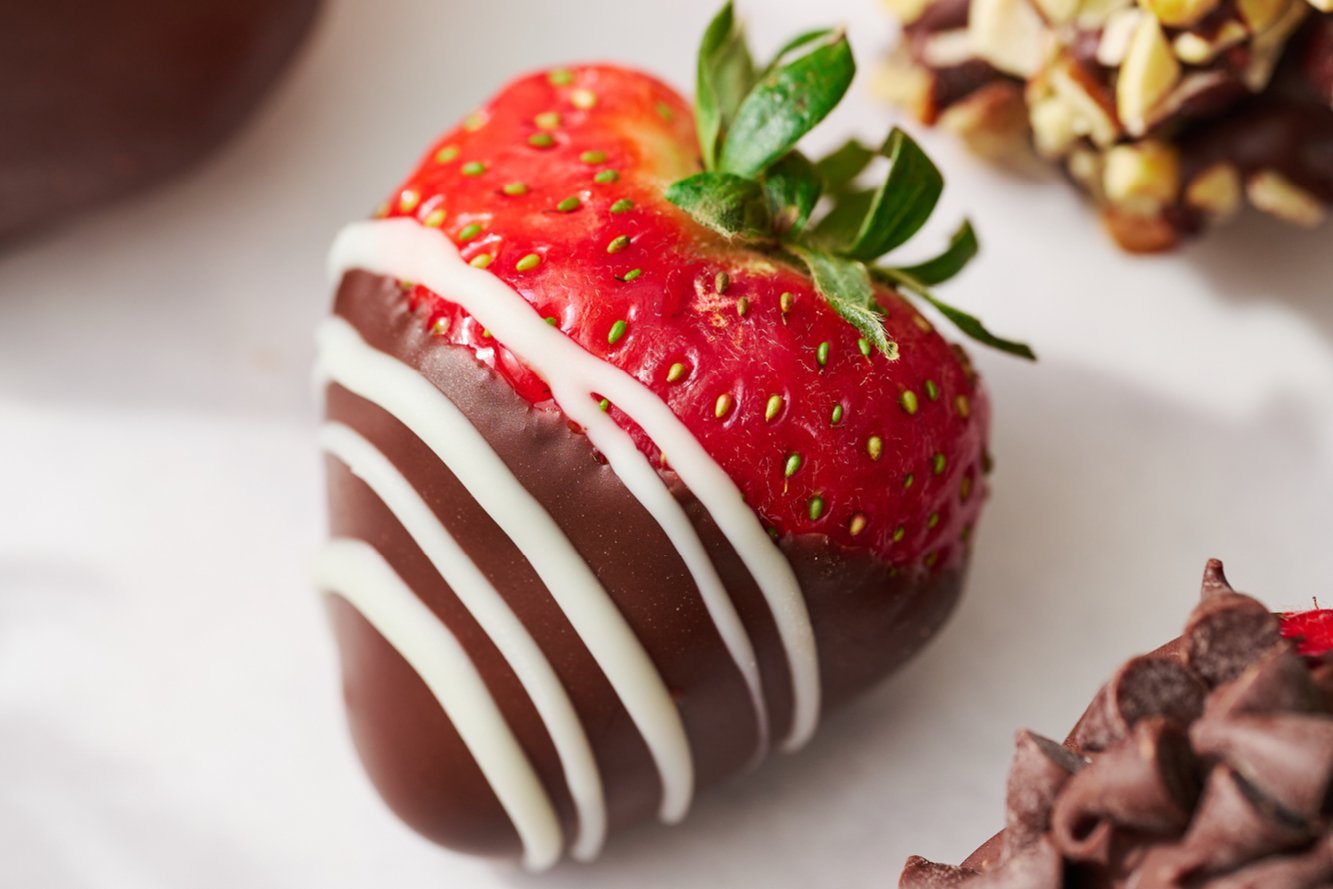 a chocolate covered strawberry drizzled with melted white chocolate