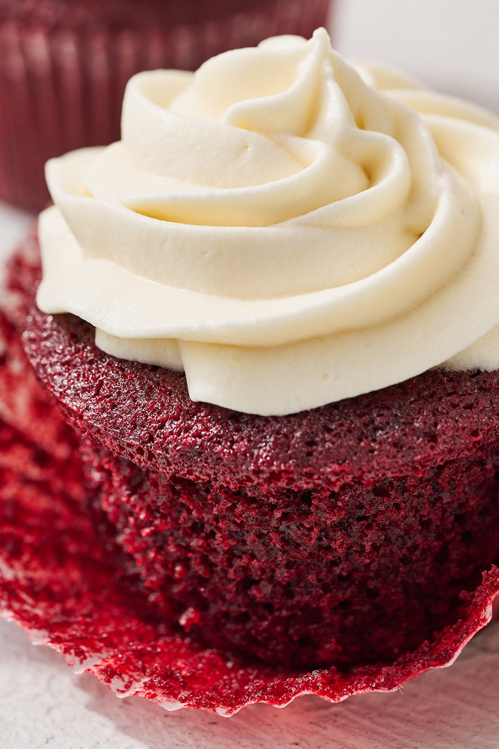 close up of one red velvet cupcake with its wrapper removed.