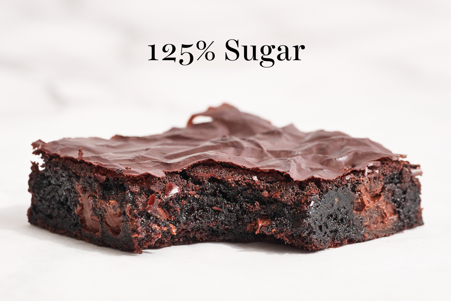 a slice of the 125% sugar brownies with a bite taken out.