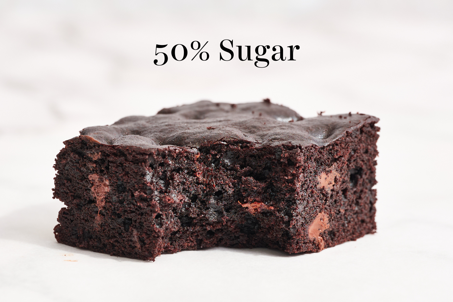a slice of the 50% sugar brownies with a bite taken out.