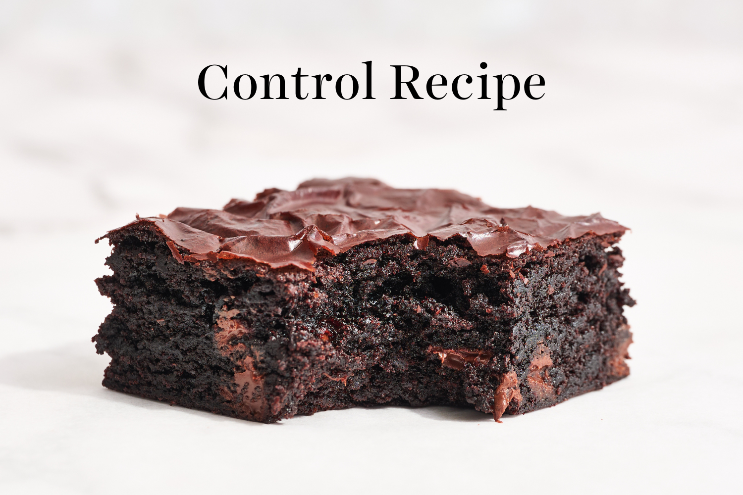 a slice of the control brownie recipe with a bite taken out.
