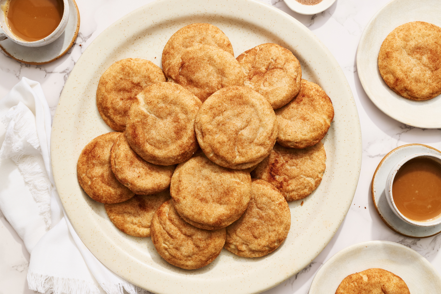 a white plate full of snickerdoodles.