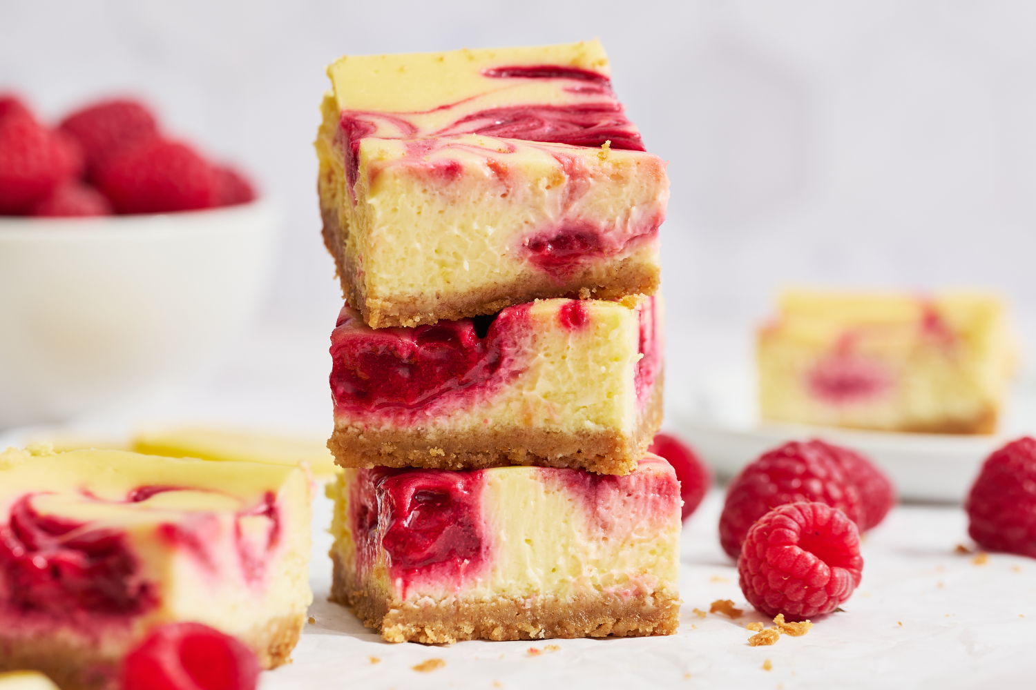 three cheesecake bars stacked on top of one another.