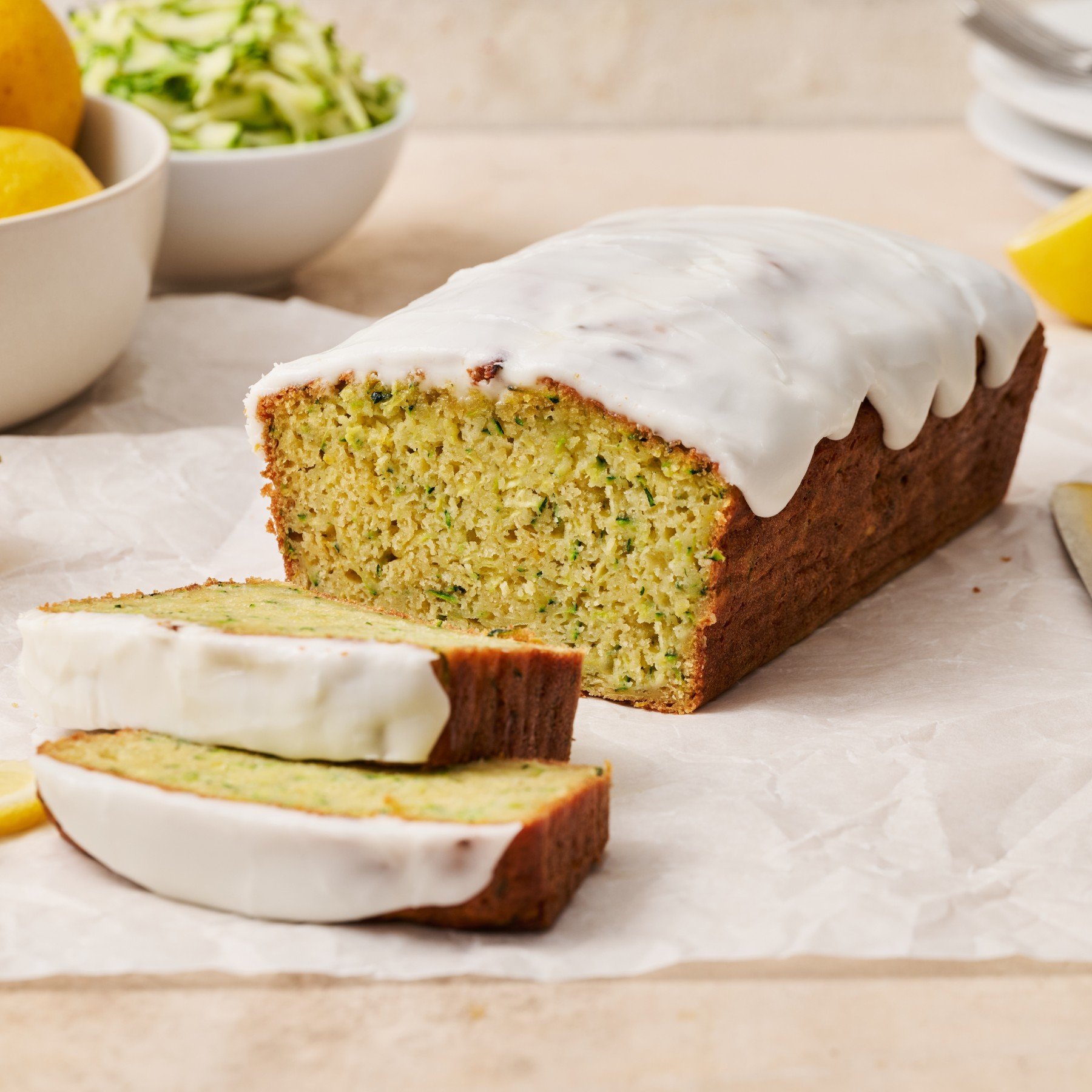 a loaf of Lemon Yogurt Zucchini Bread with a couple of slices cut and ready to serve.