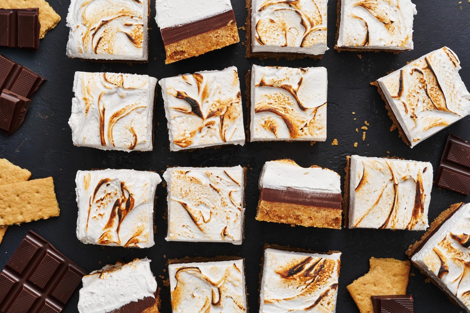 the whole pan of s'mores fudge bars, sliced neatly, with some on their sides to show the distinct layers. 