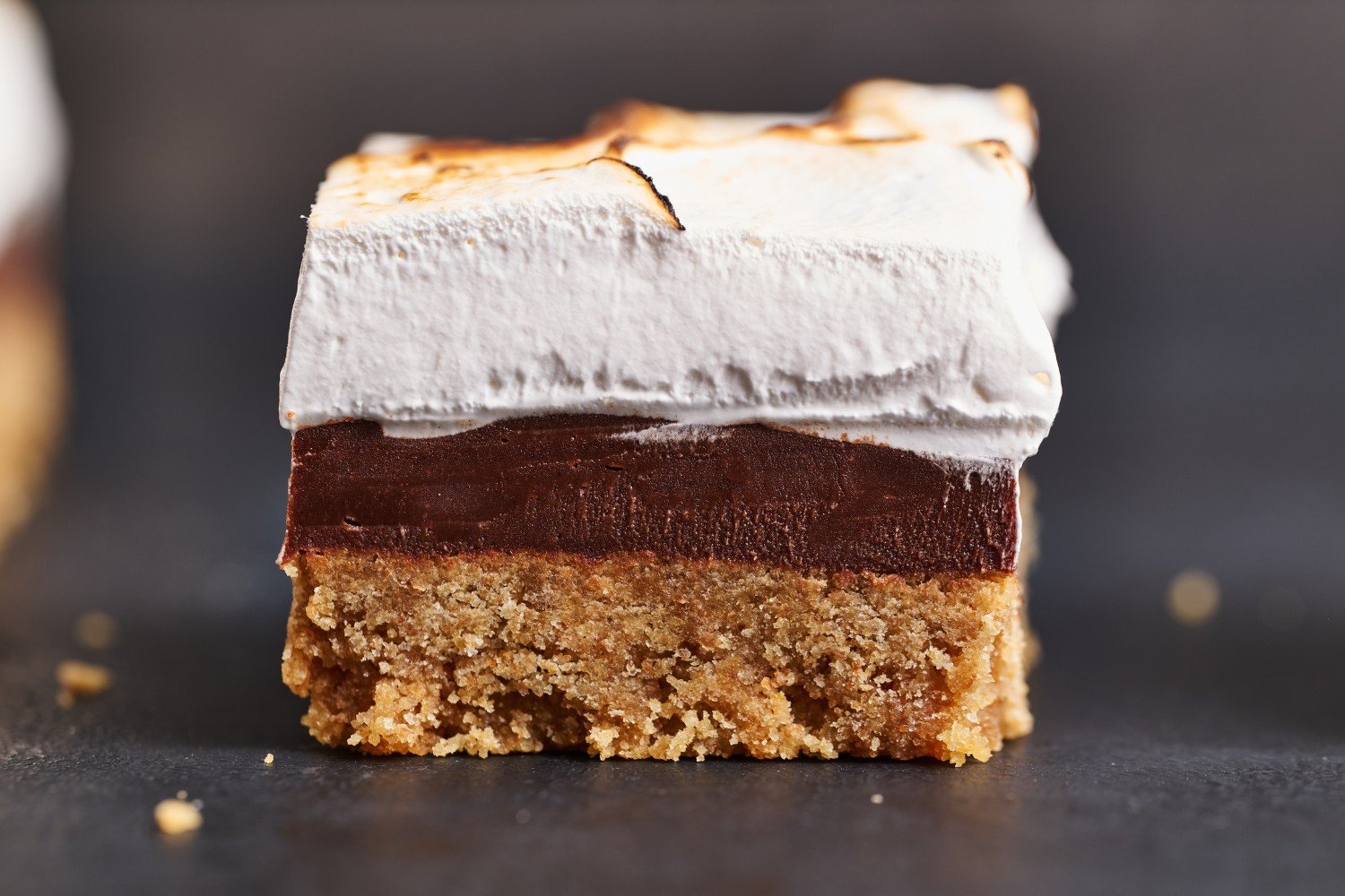 a single s'more bar on a white background, showing the bar's distinct graham cracker, chocolate, and marshmallow layers. 