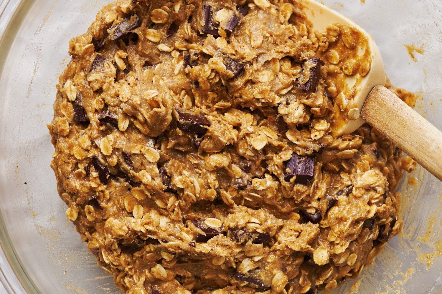 a bowl of Bourbon Rye Oatmeal Chocolate Chunk Cookie dough, ready to chill before portioning and baking.