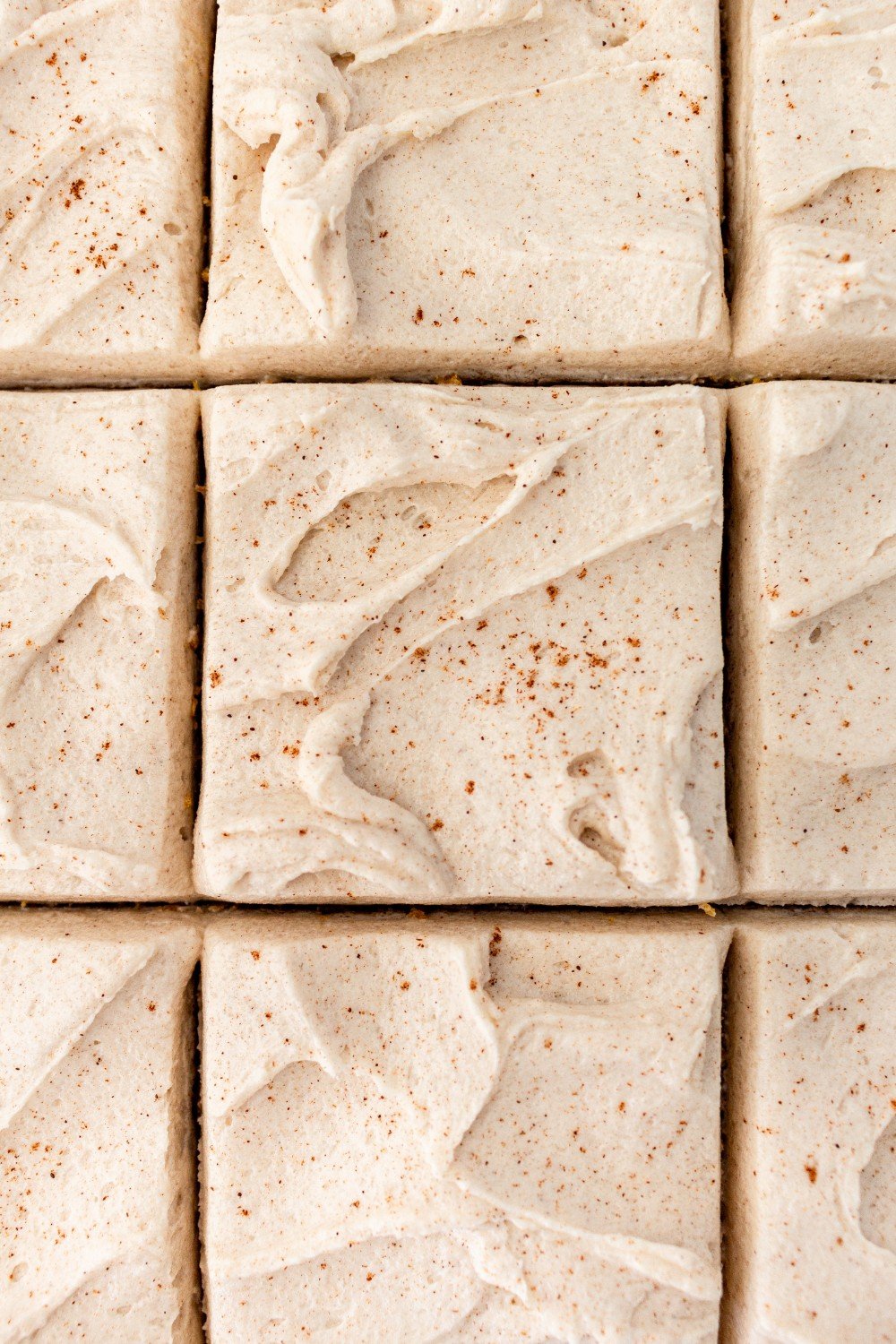 sliced bars from the top, showcasing their thick, creamy frosting.