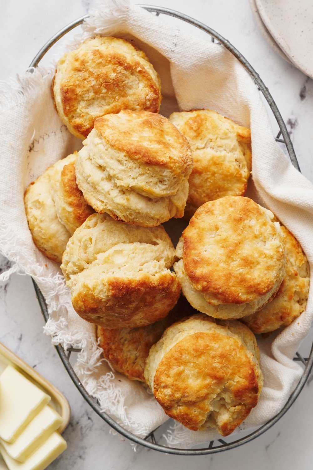 a basket of golden brown buttermilk biscuits.