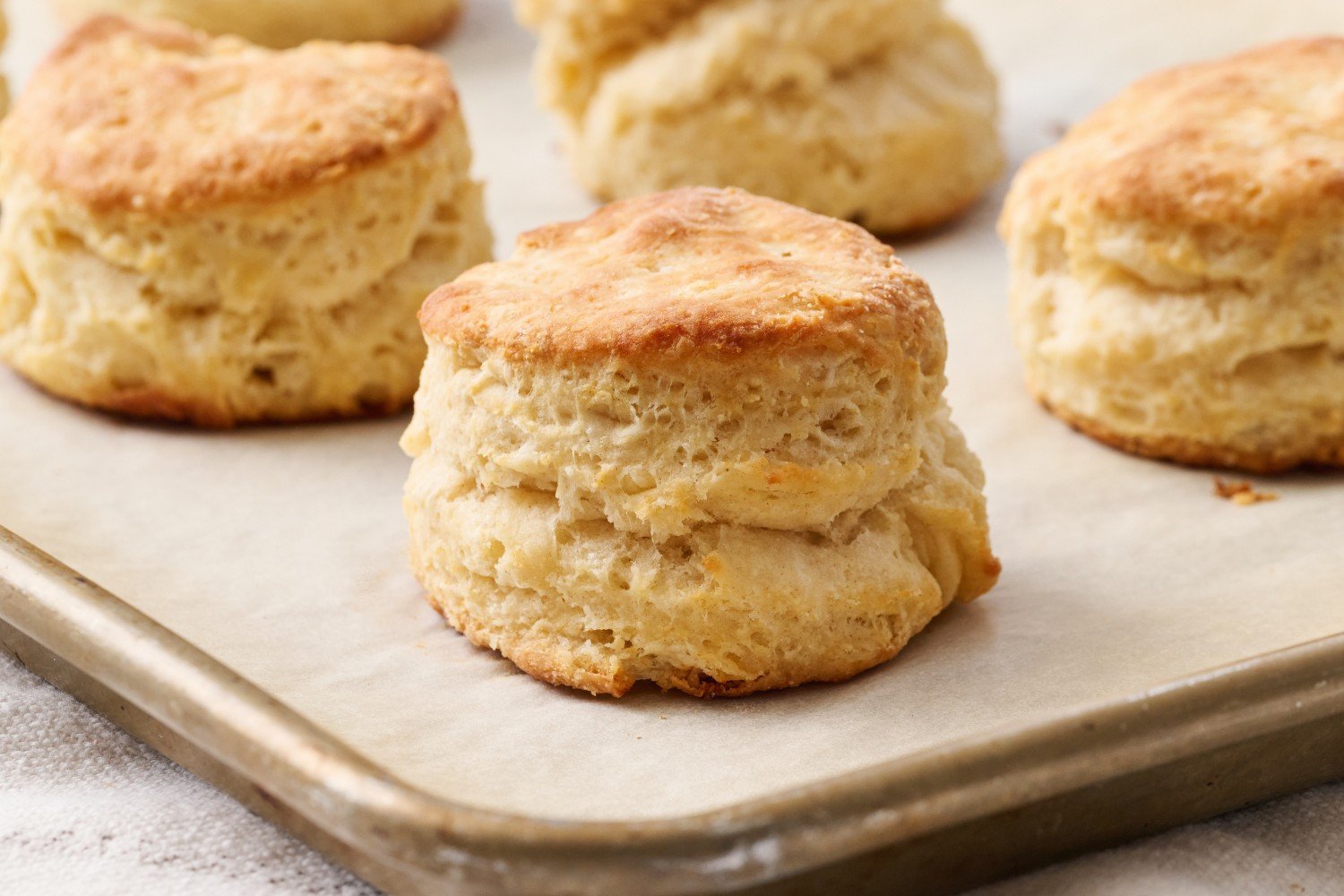 Homemade biscuits on a baking tray.