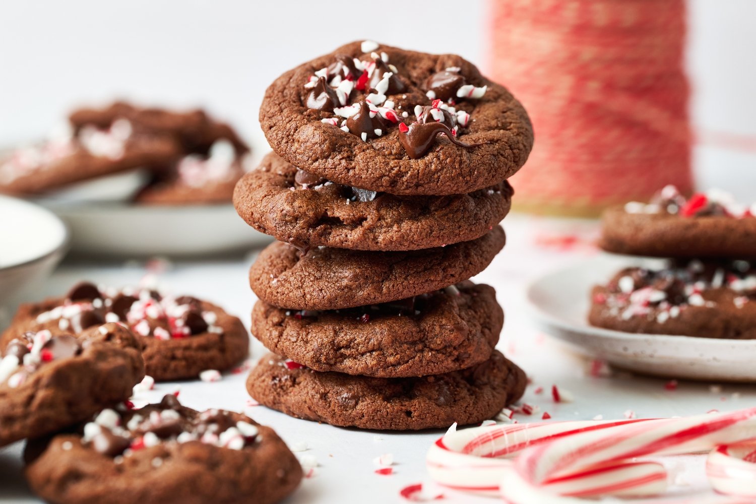 a stack of five Chocolate Peppermint Cookies with more cookies in the background.