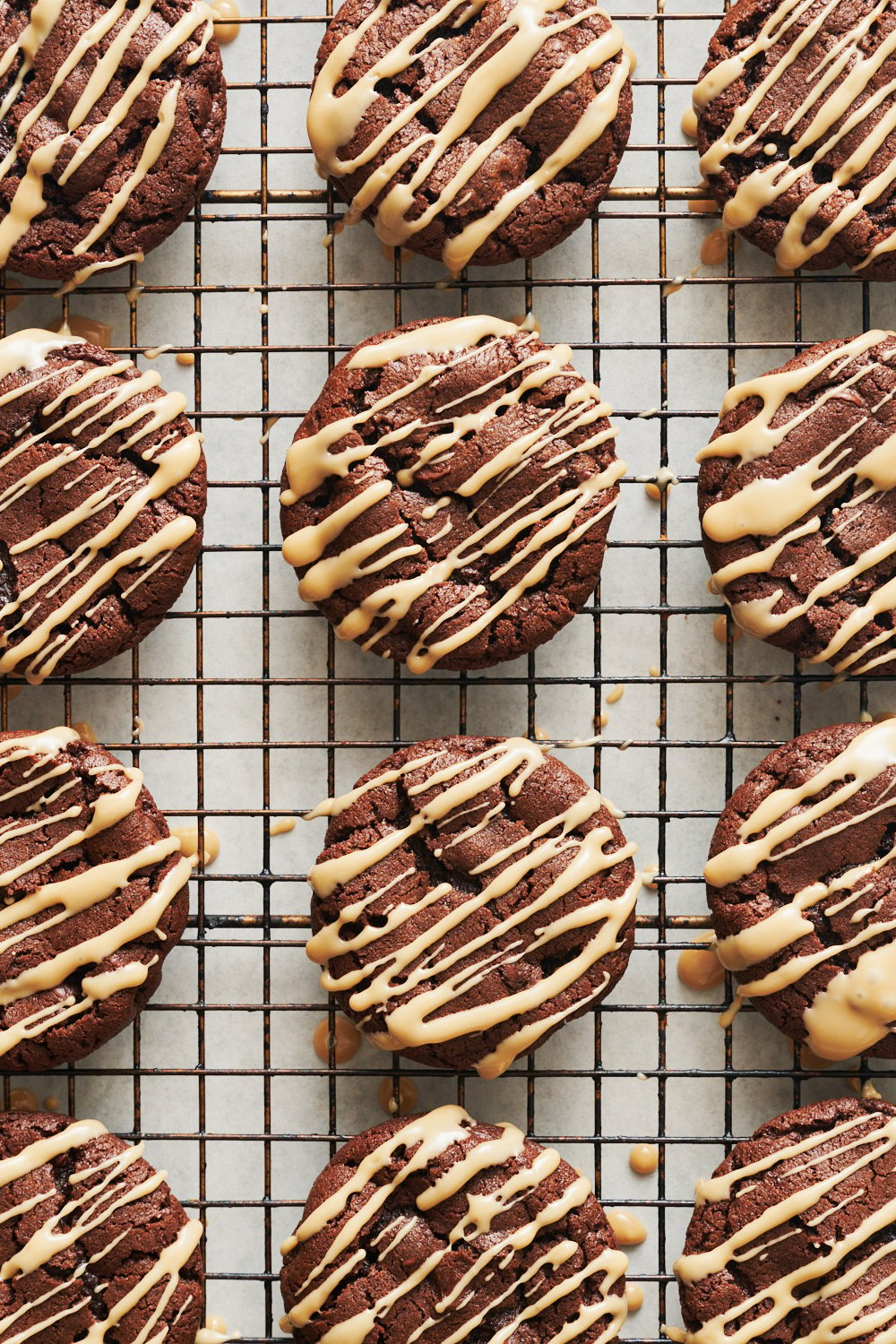 cookies in a wire rack after being iced with the coffee liqueur glaze.