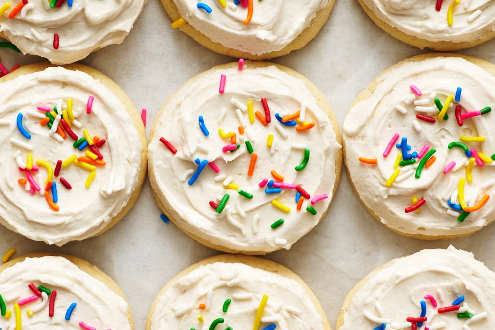 rows of iced Lofthouse Cookies with rainbow jimmies.