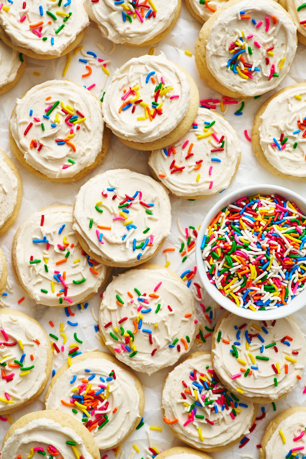 a whole batch of Lofthouse Cookies with white icing and sprinkles on top.