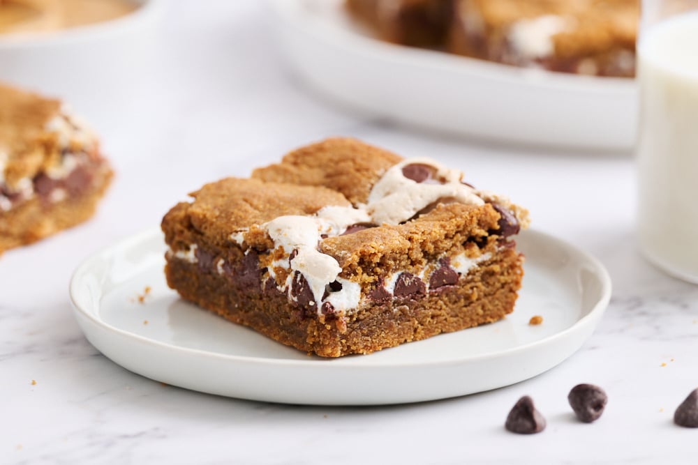 a slice of blondie on a white plate. 