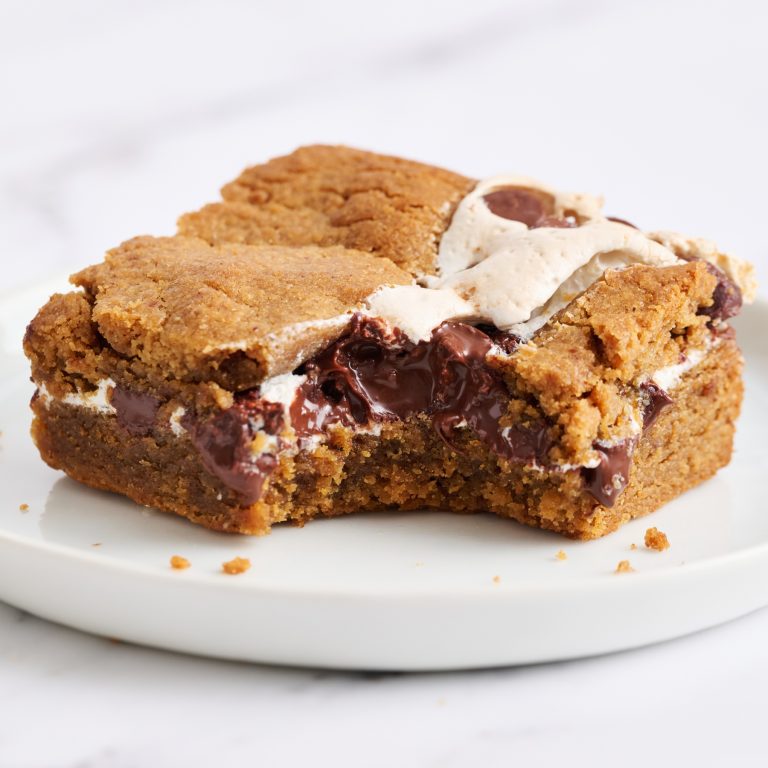 a slice of Peanut Butter S’mores Blondie on a white plate.