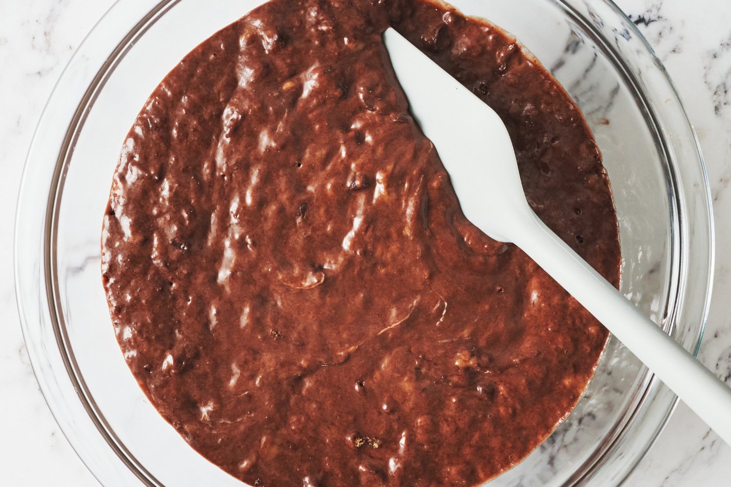 the batter in a bowl with a spoon, ready to be portioned out and baked. 