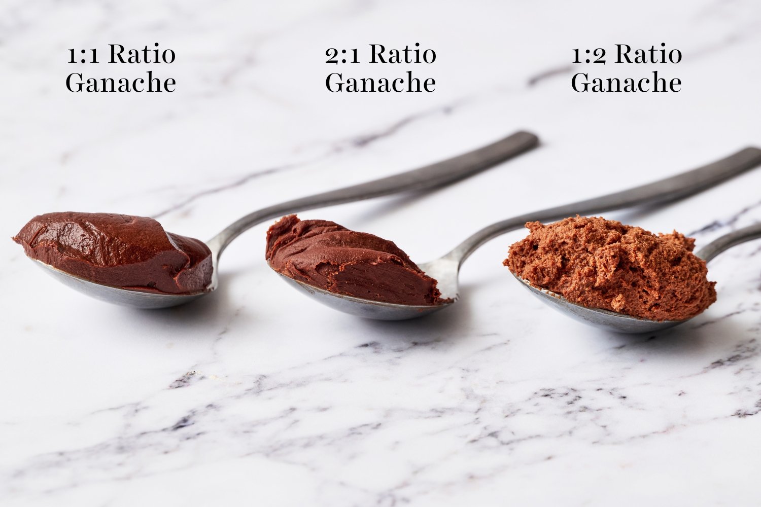 the different cream-to-chocolate ratios after being made into ganache, each displayed on a metal spoon.