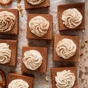 the whole batch of beer cheesecake bars with whipped cream piped on top of each.