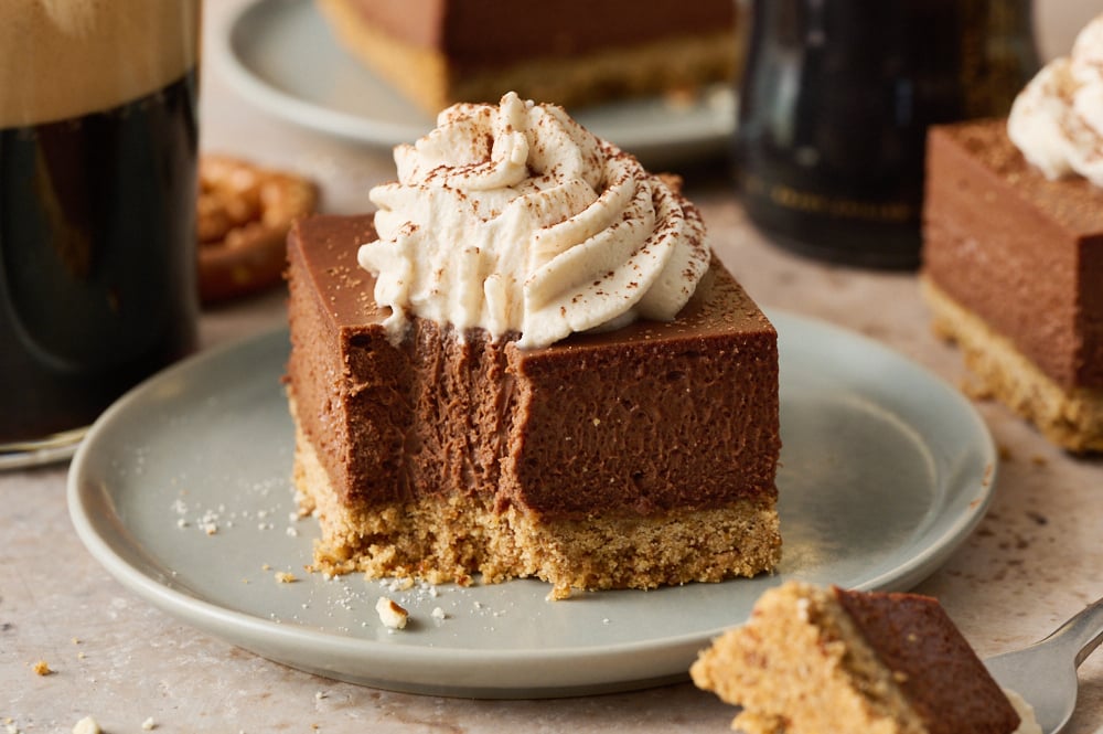 a slice of Chocolate Stout Cheesecake Bar on a plate with a bite taken out.