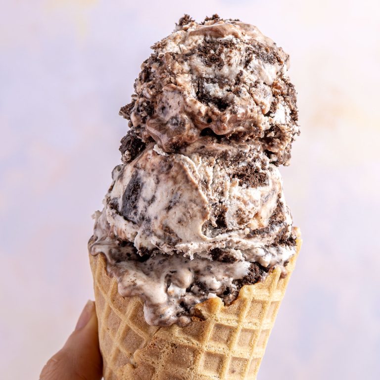 two scoops of ice cream in a waffle cone