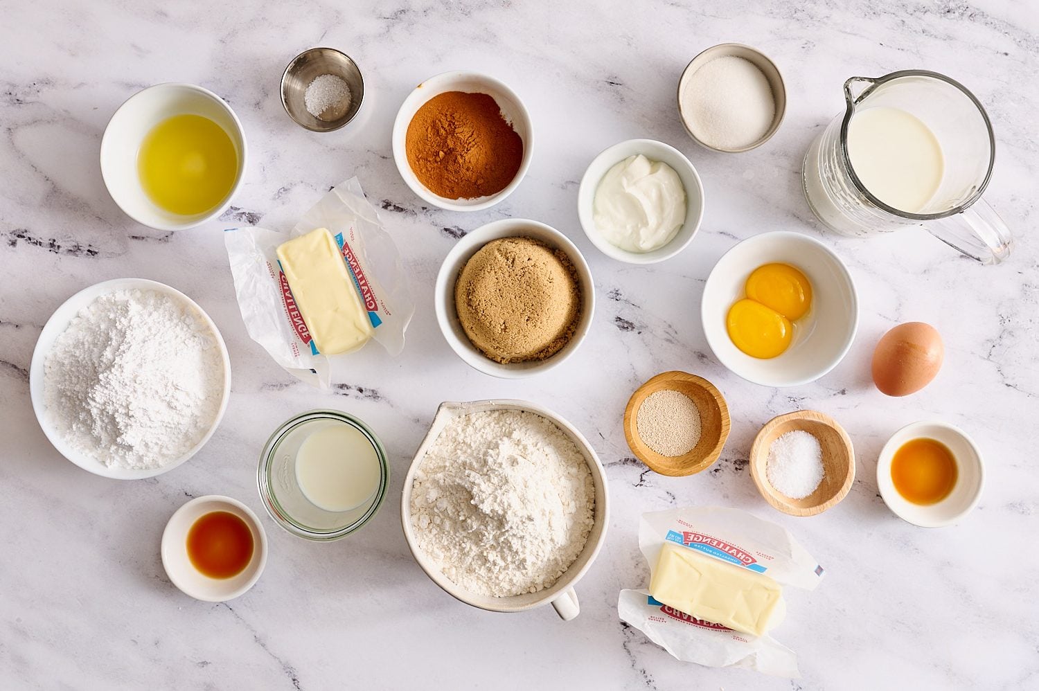 cinnamon rolls ingredients measured on a marble surface
