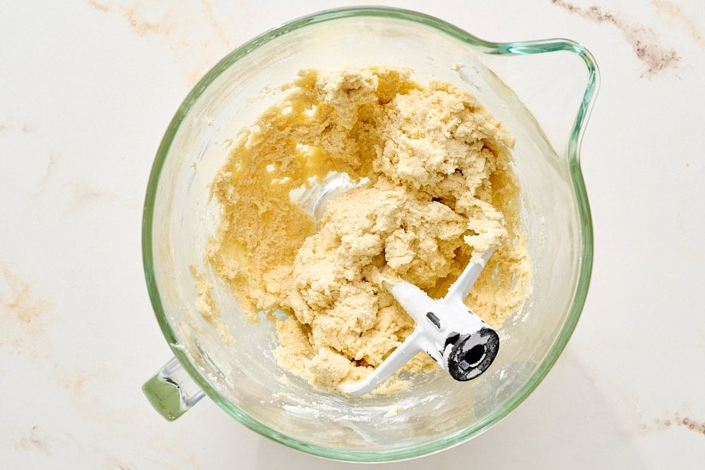 overhead view of sugar cookie dough in glass mixing bowl