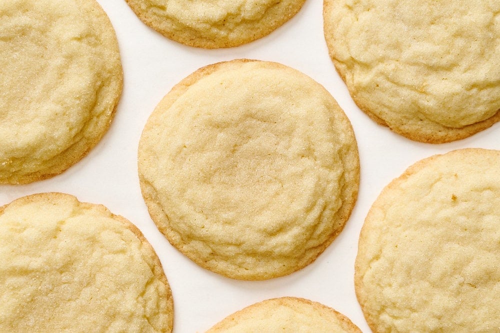 overhead view of crinkly classic sugar cookies on a plain surface