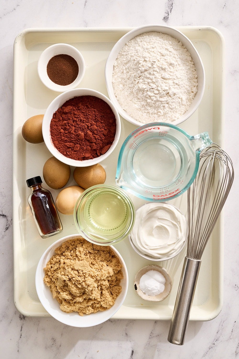 chocolate cake ingredients on a tray, portioned out and ready for baking