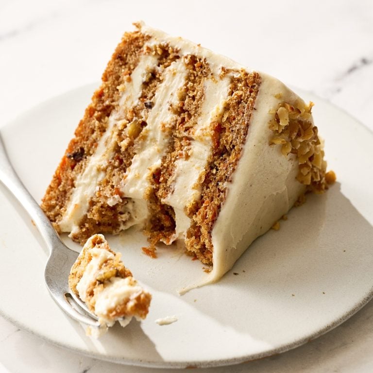 slice of brown butter carrot cake on a plate with a fork