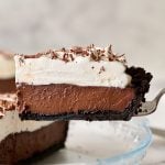 slice of chocolate cream pie being removed from pie plate