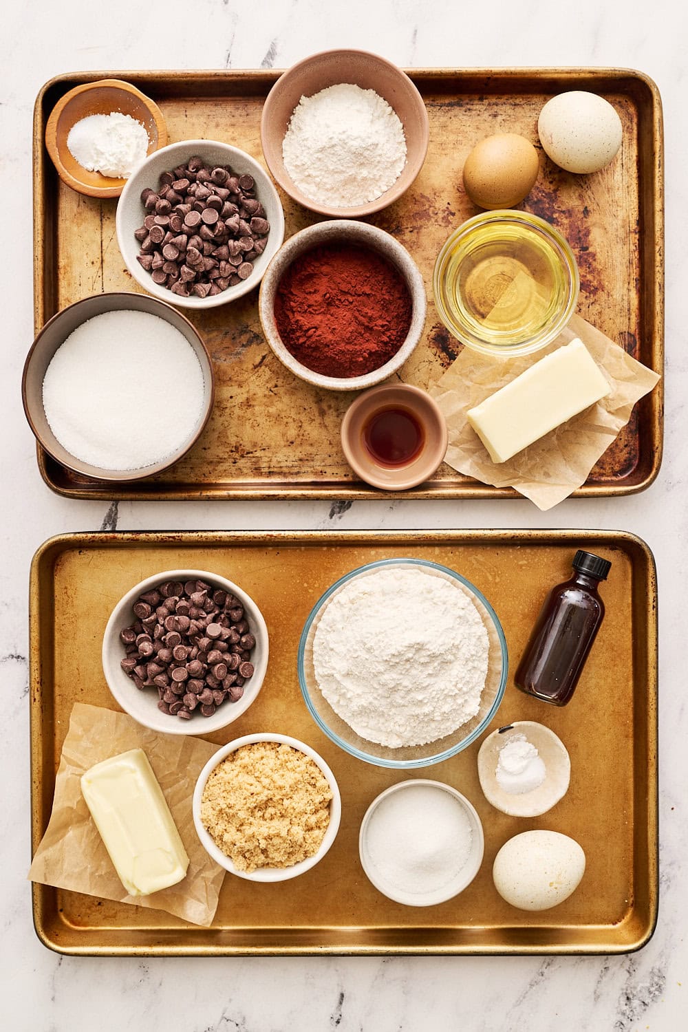 Brookie ingredients, separated by layer, on two sheet trays