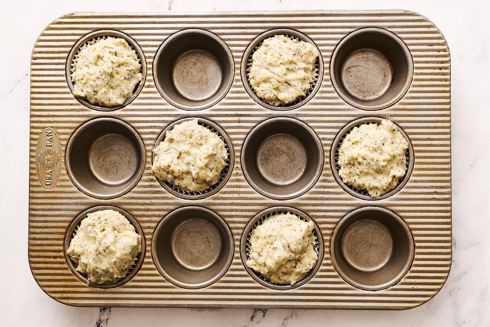 muffin batter in muffin tin, spaced into every other cavity