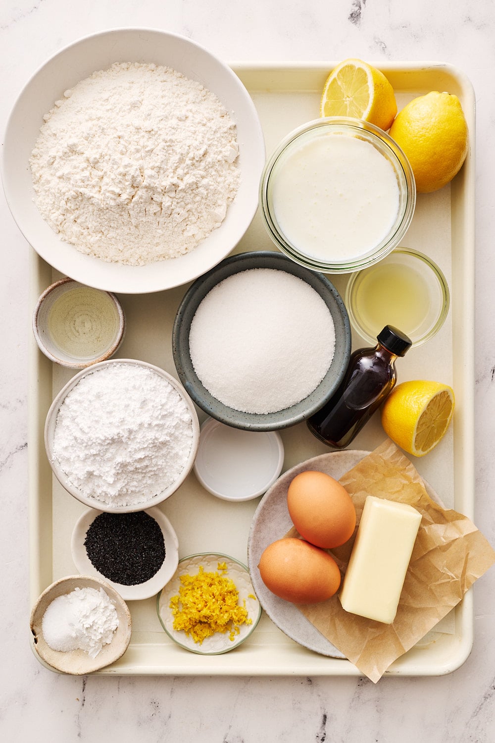 overhead view of all lemon poppyseed muffin recipe ingredients on a tray portioned and ready to go