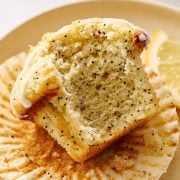 lemon poppyseed muffin on a plate with bite taken out to show soft interior