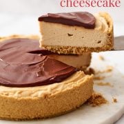 Slice of no bake peanut butter cheesecake with chocolate topping on a serving platter, ready to be served