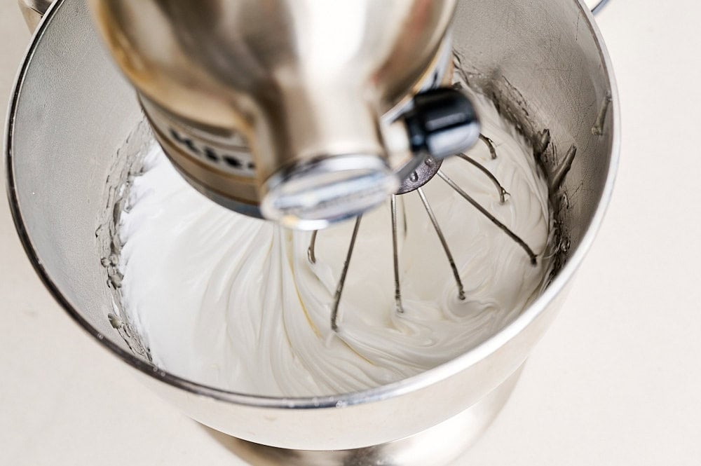overhead view inside the stand mixer bowl showing voluminous fluffy marshmallow mixture