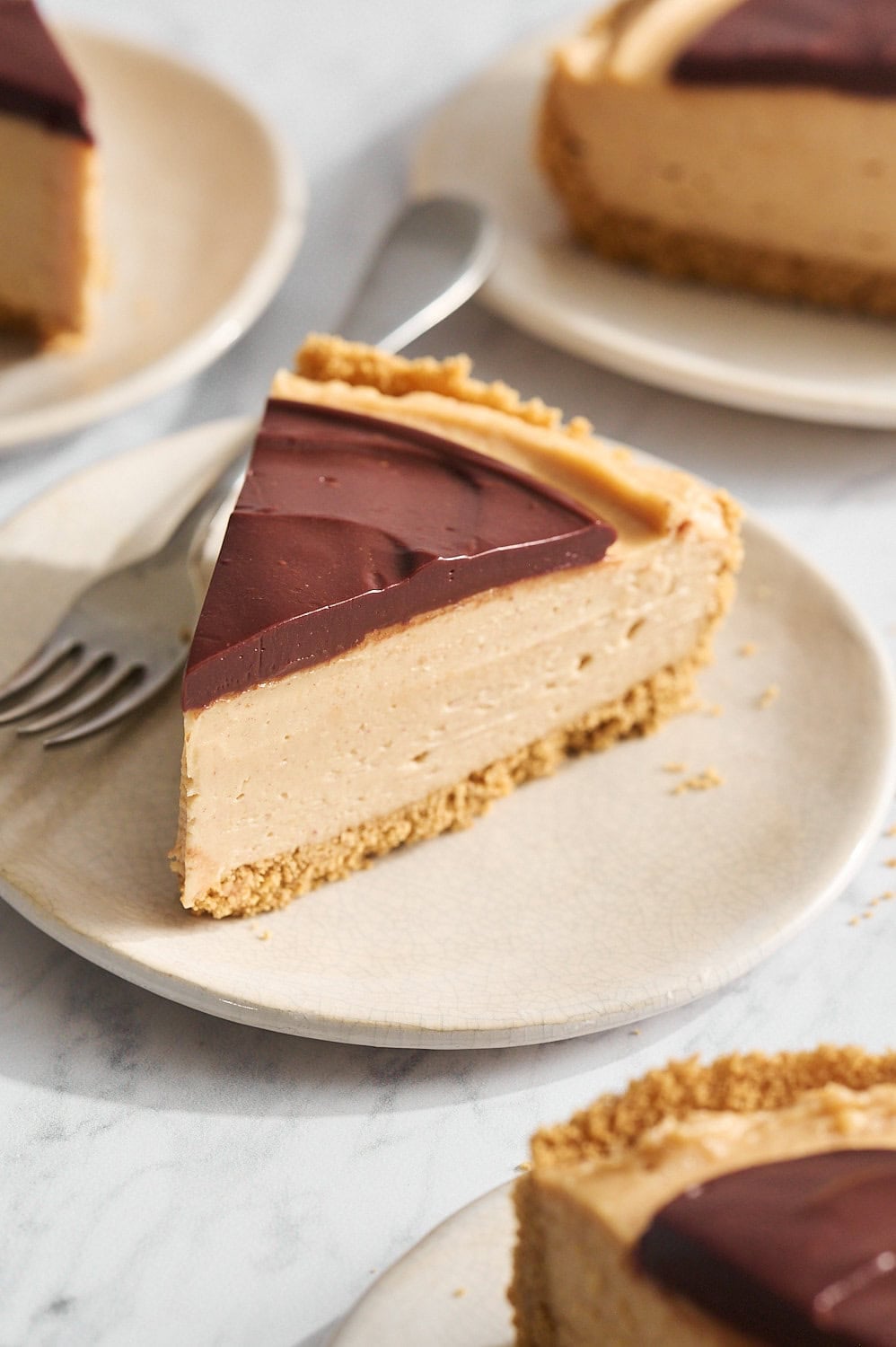 slices of cheesecake on small dessert plates on a marble surface